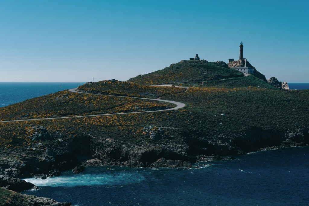 Picturesque view of Cape Vilan in Camariñas, Spain with lighthouse and ocean, perfect for travel inspiration.